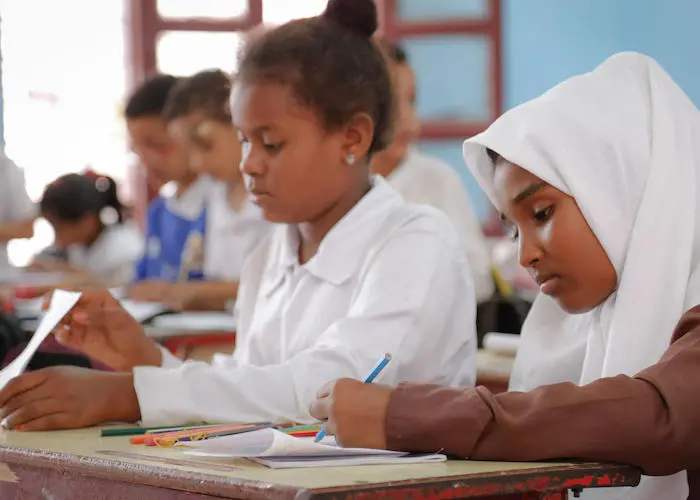 Fatima, 12, (right) and her fifth grade classmates attend the UNICEF-supported school of Saif bin The-Yazan in Aden,Yemen in 2018. 