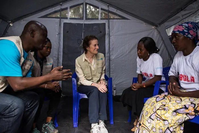 On 20 March 2019 in Butembo, Democratic Republic of the Congo, UNICEF Executive Director Henrietta H. Fore speaks with Fabiola Masika Mwengesyali (far right) and Huguette Mulyanza Vthya (black skirt), two Ebola survivors. Other UNICEF staff accompany them On 20 March 2019 in Butembo, Democratic Republic of the Congo, UNICEF Executive Director Henrietta H. Fore speaks with Fabiola Masika Mwengesyali (far right) and Huguette Mulyanza Vthya (black skirt), two Ebola survivors. Other UNICEF staff accompany them