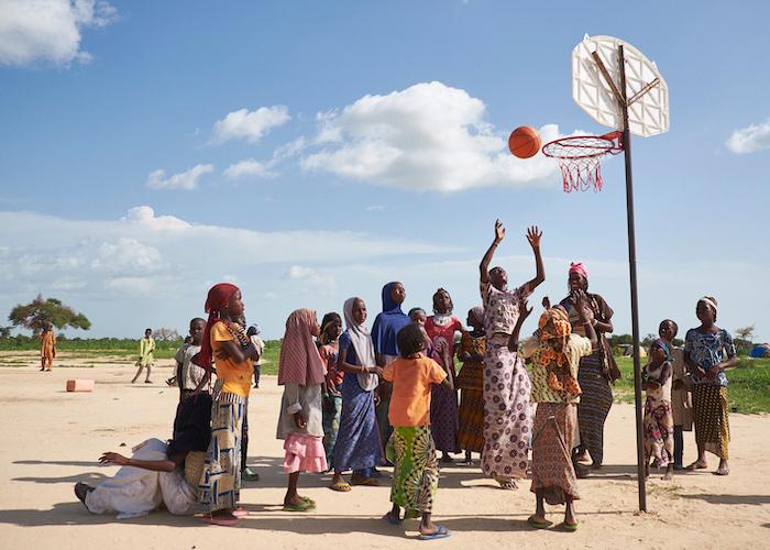 Girls play basketball at a displaced persons site in Ngagam, Niger on August 11, 2016. Recreational activities are set up by COOPI, an implementing partner of UNICEF. to create a sense of normalcy for children who have fled conflict. 