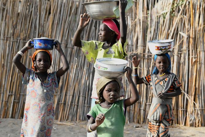 Children carry food in Bol, Chad, one of over 100 countries where UNICEF works to save and protect vulnerable children.