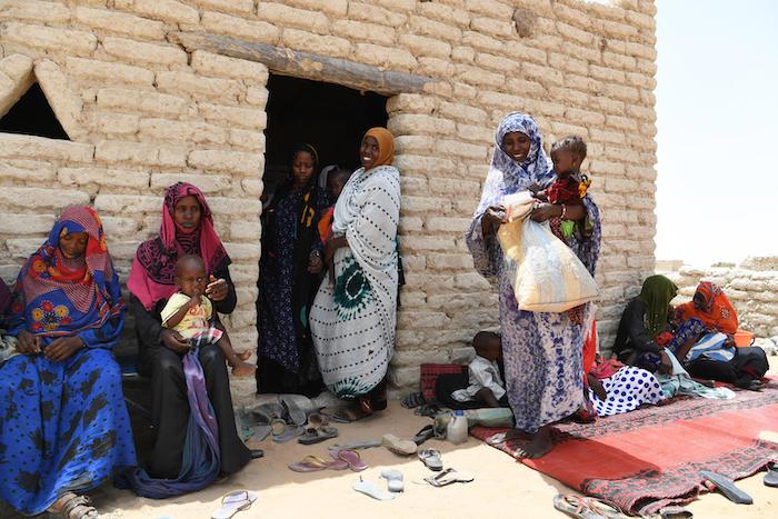 Women and children wait outside the UNICEF-supported health center in Bolingo, in central Chad, in 2019.