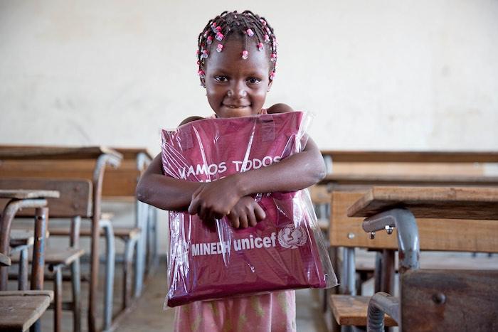 On 11 April 2019 in Beira, Mozambique, Nilda Alberta Massuve, 6, receives her education pack. UNICEF and partners distributed educations packs to learners at 12 Outobro Primary School. The school was severely damaged by Cyclone Idai. UNICEF is ramping u