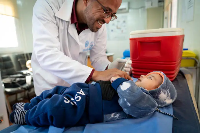 In Jordan's Azraq Refugee Camp, a UNICEF-supported doctor vaccinates 4-month-old Malek, whose family fled Syria three years ago. 