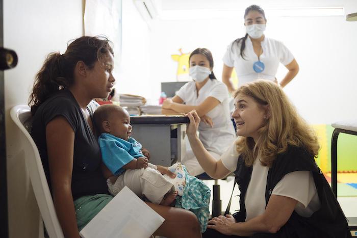 On April 23, 2019 in Cucuta, Colombia, UNICEF Director of the Division of Communication Paloma Escudero speaks with a woman and her child at the UNICEF-supported health center. 
