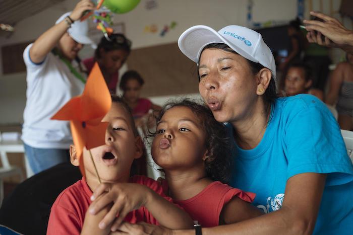On April 25, 2019, volunteer Pureza Peña, right, plays with children from Venezuela as part of a UNICEF-supported program for migrant families in Colombia. 