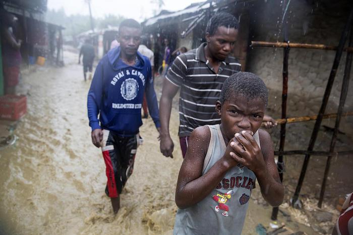 On April 28, 2019, a boy walks through flood waters during heavy rains in the Shibaburi area of Pemba, Mozambique in the wake of Cyclone Kenneth. 