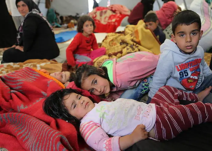 On May 9, 2019 near Kafr Lusein, Syria, families fleeing hostilities share group tents provided by the Turkish Red Crescent. 