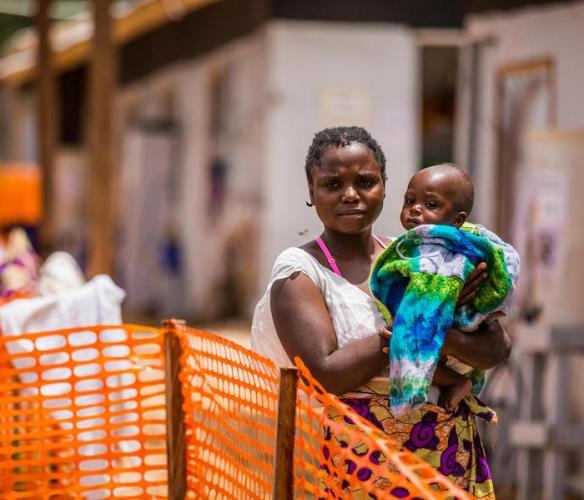 Masika Mbweki, 31, holds her son, Japhet, 10 months, by their room in the quarantine area of the Ebola Teatment Centre of Butembo, Democratic Republic of Congo, 22 March 2019. 