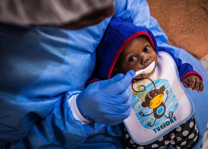Ebola survivor Ruth Lafleussante, 19, cares for 7-month-old Christ-Vie in the UNICEF-run nursery for babies and young children affected by the virus at the Ebola Treatment Center of Butembo in North Kivu, Democratic Republic of Congo on March 23, 2019. 