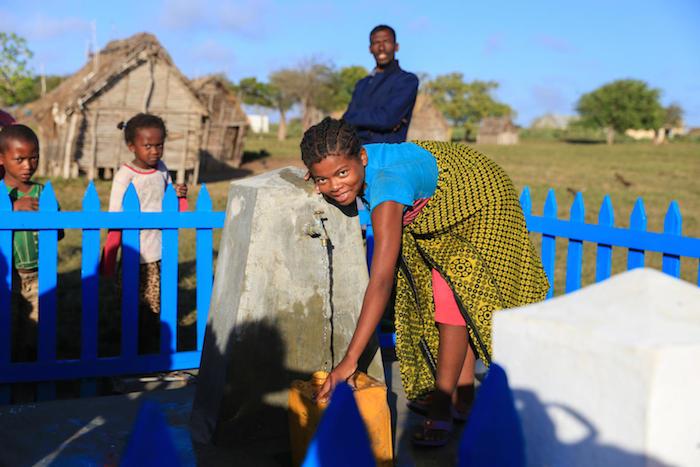 A girl in Southern Madagascar taps into her community's new source of safe water.