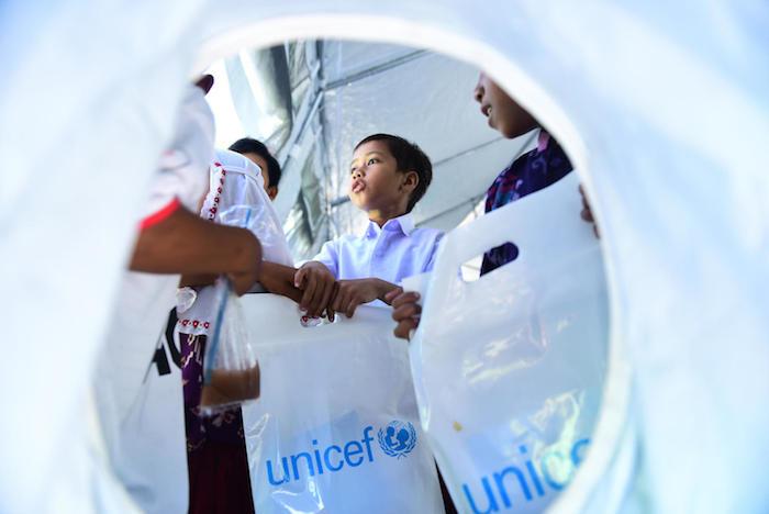 Elementary school students in Talise Village, Palu, Indonesia, receive school supplies from UNICEF to help them get back to learning shortly after their village was destroyed by an earthquake and tsunami.
