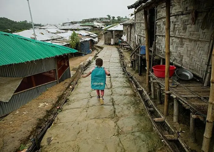 On July 13, 2019, a young Rohingya refugee walks to a UNICEF-supported learning center in Omani Site, Camp-21, Teknaf, Cox's Bazar, Bangladesh. 