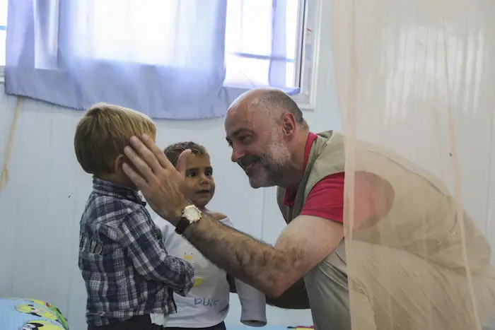 UNICEF Syria Representative Fran Equiza interacting with children at a UNICEF-supported interim care center in Al-Hol camp, northeast Syria, July 2019. 