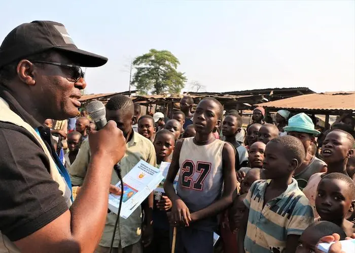 On August 7, 2019, Jean Louison Miango Makunda, UNICEF Burundi's Communication for Development (C4D) consultant on Ebola preparedness, speaks with children and distributes brochures in Gatumba, Burundi. On August 7, 2019, Jean Louison Miango Makunda, UNICEF Burundi's Communication for Development (C4D) consultant on Ebola preparedness, speaks with children and distributes brochures in Gatumba, Burundi.