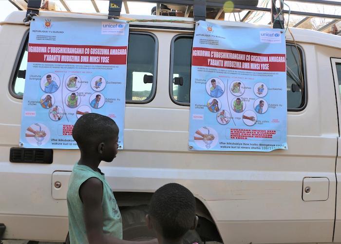 In Gatumba, Burundi, a boy examines posters as part of an Ebola awareness campaign organized by UNICEF Burundi's Communication for Development (C4D) team. 