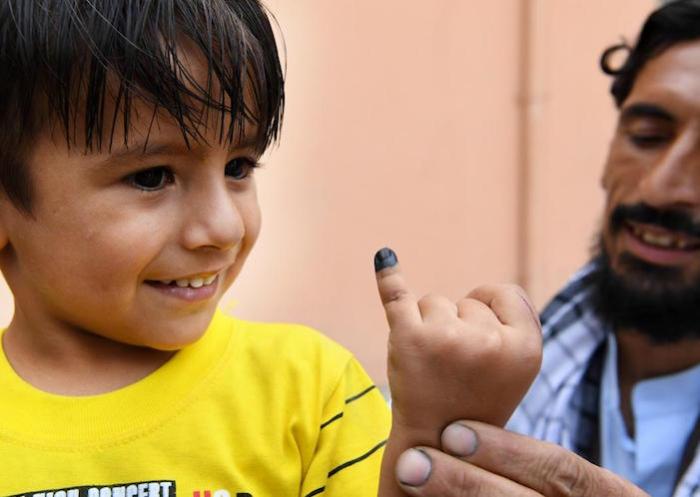 A child’s finger is marked after he is vaccinated against polio. UNICEF-supported vaccinators went door-to-door in his neighborhood of Kart-e-Naw, a suburb of Kabul, Afghanistan.