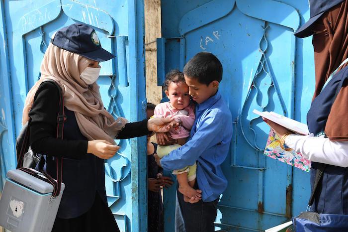 Polio vaccinators go door to door in Kart-e-Naw, a suburb of Kabul, Afghanistan.&nbsp;