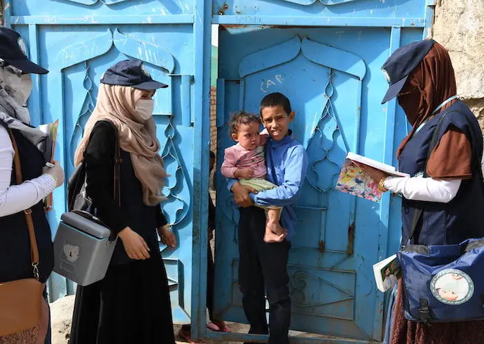 UNICEF-supported polio vaccinators go door-to-door in Kart-e-Naw a suburb of Kabul, the capital of Afghanistan, on August 26, 2019.