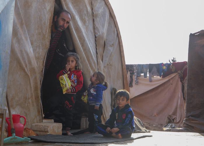 On November 16, 2019, a Syrian family displaced by violence shelters from the cold in an informal tented settlement in Killi, Idlib Governate, Syria, near the border with Turkey. 
