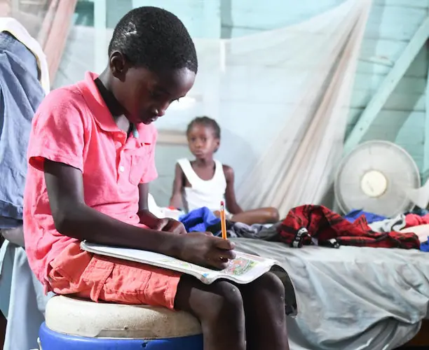 Joel, in Jamaica's Westmoreland parish, did schoolwork at home while his school was closed due to coronavirus concerns. 