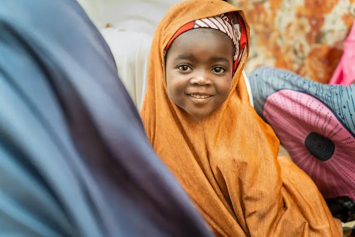 Umme, 4, photographed while attending a community meeting about healthy practices led by a UNICEF-trained volunteer — one of 20,000 volunteers who are the backbone of community outreach.
