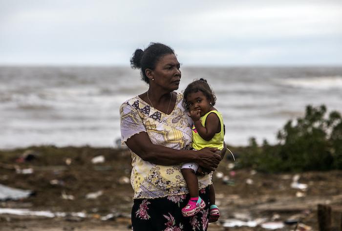 A mother and child survey the damage to their El Muelle neighborhood in Bilwi, Puerto Cabezas, Nicaragua, following Hurricane Eta on Nov. 5, 2020.