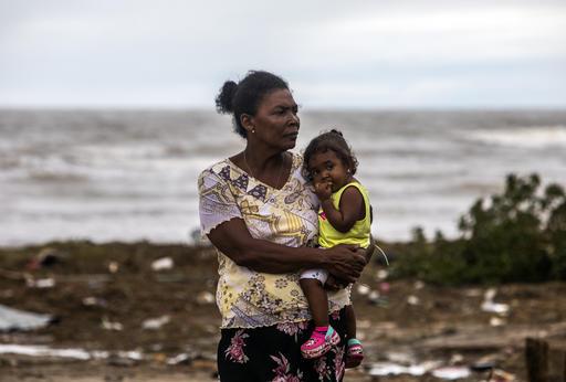 After Hurricane Eta hit Central America in 2020, many mothers and children were left with nothing. Here, one mom holds her baby as she surveys the rubble in their neighborhood in Puerto Cabezas, Nicaragua. The Inspired Gift collection offers essential sup