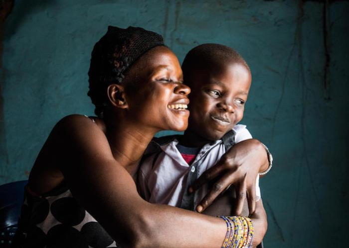 On November 10, 2020, in Mbandaka, Democratic Republic of Congo, Nadege hugs her son David. The two are both Ebola survivors.