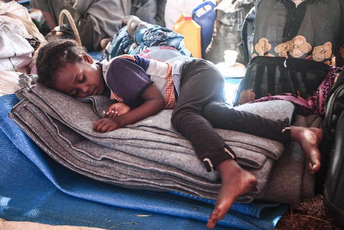 An Ethiopian refugee child who fled fighting in Tigray province sleeps in a hut at the Um Raquba camp in Sudan's eastern Gedaref province.