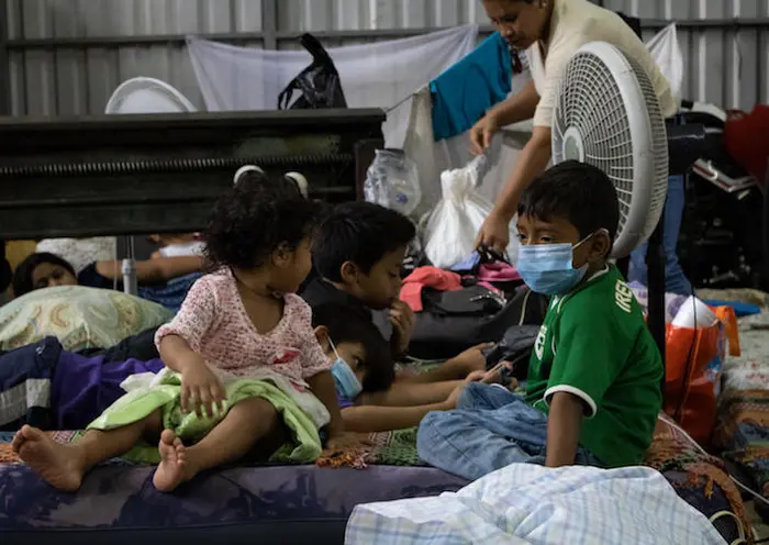 When back-to-back hurricanes Eta and Iota hit Central America in 2020, families crowded into improvised shelters, like this one in San Pedro Sula, Honduras.