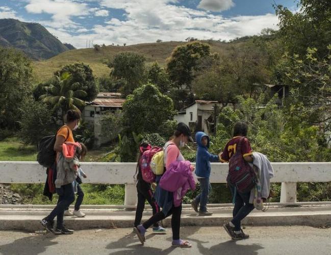 Migrant children and women walk along a road in Guatemala, en route to Mexico from Honduras.