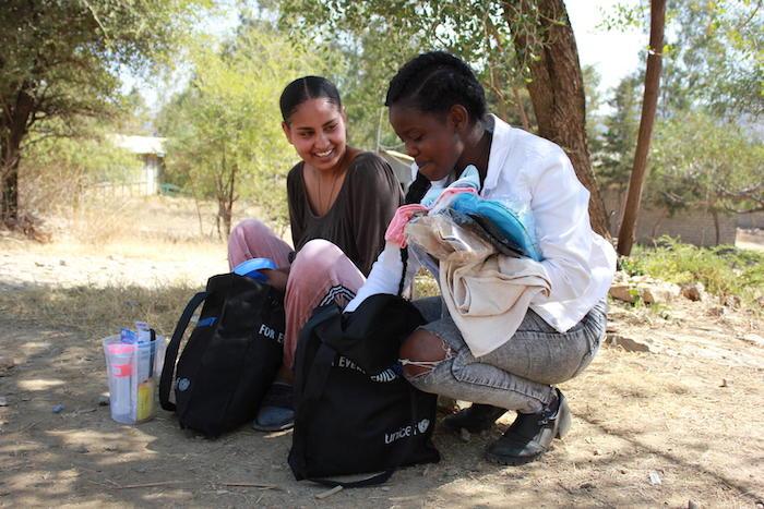 Eighteen-year-old Feven, left, and 20-year-old Senait, both uprooted by conflict in the Tigray region of Ethiopia, receive UNICEF dignity kits containing emergency supplies on Jan. 15, 2021.
