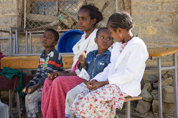Tsega-brhan Mebrahtu, 27,&nbsp;and&nbsp;her three children — Milen, 3, with biscuit; Abel, 6, left, and Arsema, 10, right — were displaced from Tigray's western zone and are staying in the town of Mekelle, where they are able to receive assistance from UNICEF.