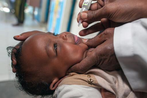 A child receives an oral polio vaccine at a UNICEF-supported nutrition health center in Hargeisa, Somaliland. The Survive, Then Thrive gift basket includes polio vaccines and other essentials such as therapeutic food and mosquito nets.