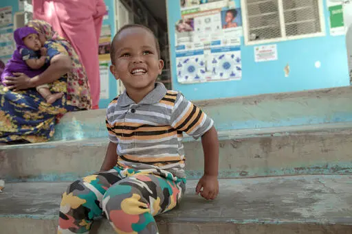 Mohammed, 2, sits on the steps of a UNICEF-supported nutrition health center in Hargeisa, Somaliland, where both mothers and babies get the care they need to survive and thrive. Shop UNICEF Inspired Gifts.