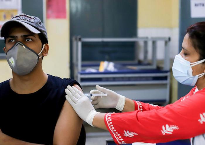 A health worker inoculates a man with a dose of the COVID-19 coronavirus vaccine in a school-turned-vaccination center in New Delhi, India on May 5, 2021.
