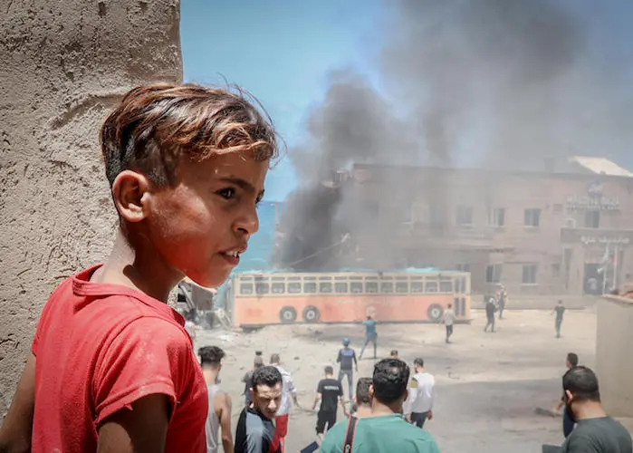 On May 17, 2021, a Palestinian child stands in front of the Gaza port, which was targeted by Israeli bombardment during the recent escalation.