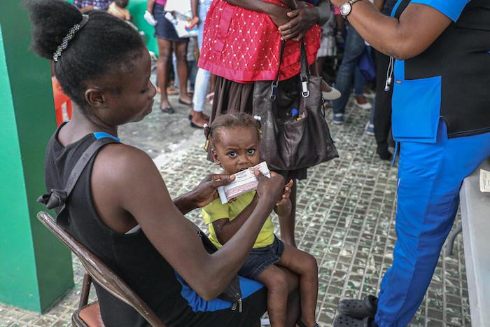 A malnourished child is given therapeutic food at a health facility in Saint-Jean-du-Sud, Haiti, on May 26, 2021.
