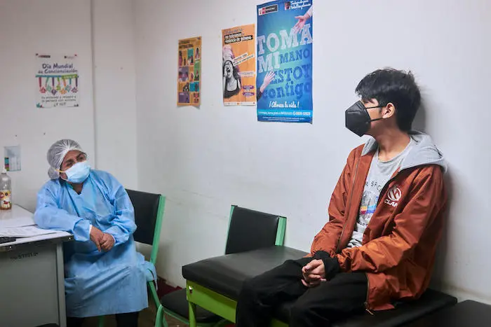 Psychiatrist Dr. Maria Saire meets with Andre (name changed), 14, at the Community Mental Health Center in Carabayllo, a district in the north of Lima, Peru.