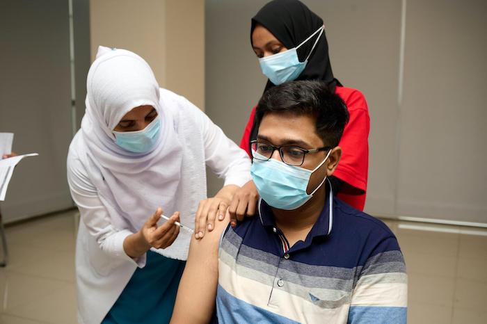 Health worker Mohammad Mofiz is vaccinated against coronavirus at Bangabandhu Sheikh Mujib Medical University, Dhaka, Bangladesh.