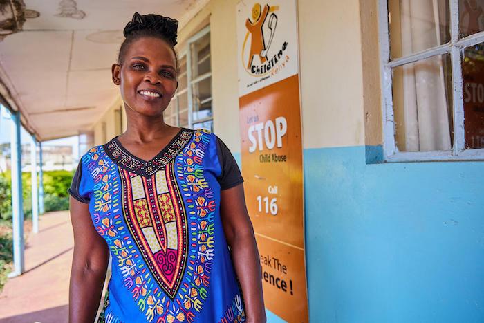 Helpline counsellor Barbra Sillingi stands outside the Childline Kenya call center where she works in Lower Kabete, on the outskirts of Nairobi.