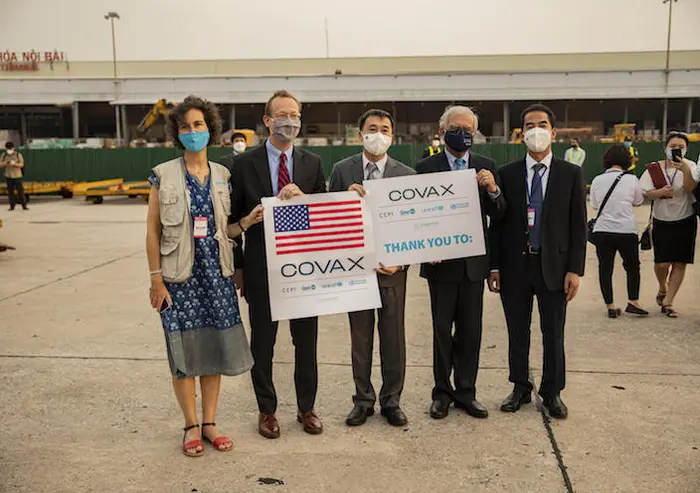 UNICEF Vietnam Deputy Representative Lesley Miller, far left, and fellow officials greeted the arrival of COVID-19 vaccine doses donated by the U.S. Government in Hanoi on July 25, 2021.