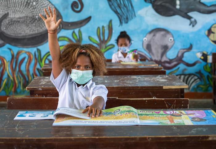 A student, Paula, raises her hand during class at UNICEF-supported Yosiba Elementary School in Simporo, Papua Province, Indonesia, on June 15, 2021.