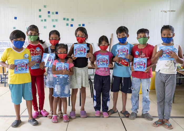 Boys and girls celebrate their return to school with coloring books and masks at Chiguatillo Fiscal School, Playa Grande Community, Esmeraldas, Ecuador in 2021.