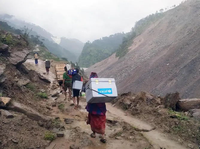 UNICEF team travels on foot to deliver vaccines and other health supplies to the Bajura district in far-western Nepal. UNICEF team travels on foot to deliver vaccines and other health supplies to the Bajura district in far-western Nepal.