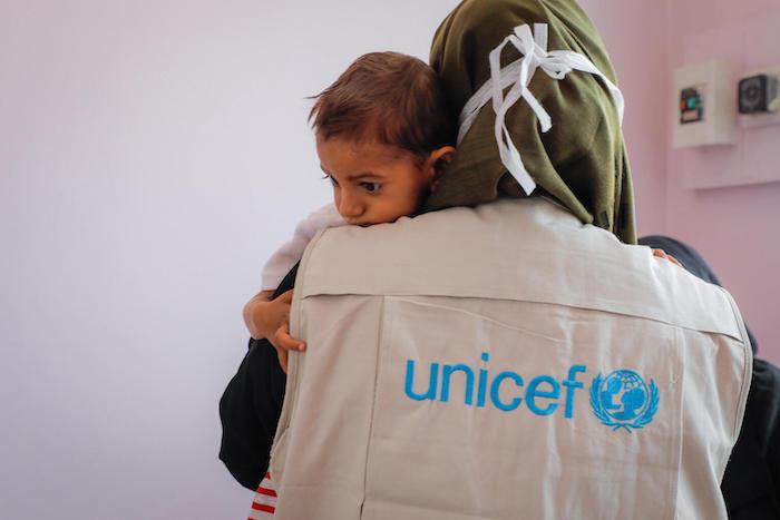 A UNICEF health and nutrition officer holds 2-year-old Aseel who is being treated for severe acute malnutrition at a UNICEF-supported hospital in Sana'a, Yemen.