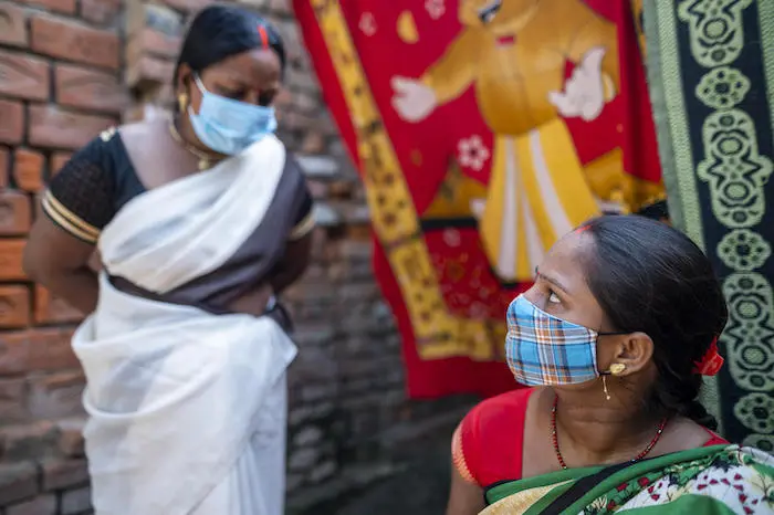 Bhavna Devi, left, an Accredited Social Health Activist (ASHA), counsels 25-year-old mother Priya Devi on caring for her newborn baby In Varanasi, Uttar Pradesh, India. 