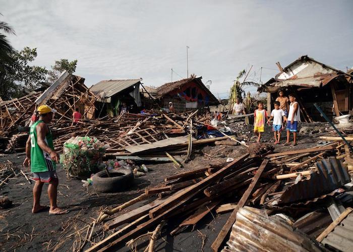 Residents salvage belongings from their destroyed homes in the coastal town of Dulag in Leyte province on December 17, 2021, a day after Super Typhoon Rai hit.