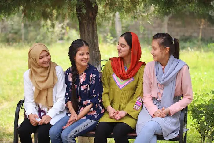 16-year-old Waranga Sarfaroz with her four teammates from the UNICEF UPSHIFT program sit outside 16-year-old Waranga Sarfaroz with her four teammates from the UNICEF UPSHIFT program sit outside