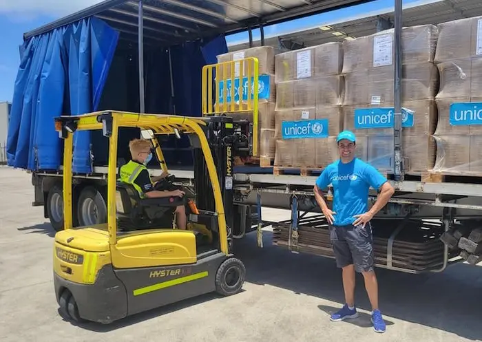 UNICEF Pacific Ambassador Pita Taufatofua stands in front of UNICEF's pre-positioned emergency supplies to be sent to Tonga from Brisbane, Australia. UNICEF Pacific Ambassador Pita Taufatofua stands in front of UNICEF's pre-positioned emergency supplies to be sent to Tonga from Brisbane, Australia.